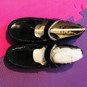 Black, patent leather, kids Mary Jane shoe.